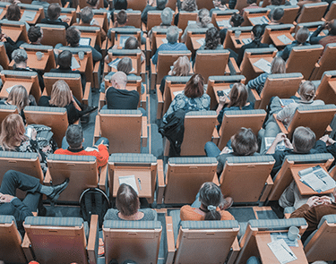 University students attending a class in an auditorium